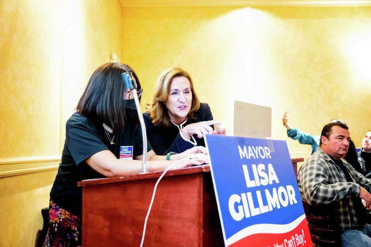 Santa Clara Mayor Lisa Gillmor monitors election results with campaign volunteer Yuki Ikezi during an election night gathering on Tuesday, Nov. 8, 2022, in Santa Clara, Calif.