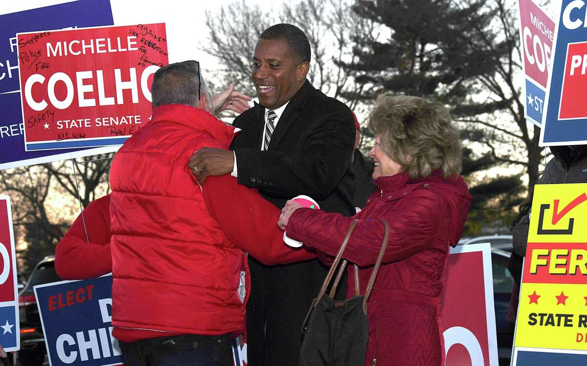 Republican George Logan candidate for Congress in the 5th Congressional district, gathers with supporters to greet voters as they leave the Danbury High School polling place Election Day, Tuesday, Nov. 8, 2022.