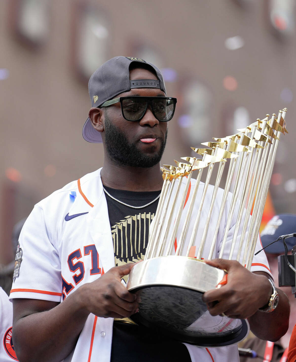 Houston Astros designated hitter Yordan Alvarez holds the 2017 World Series trophy in the 2022 World Series Championship Parade. He's scheduled to meet fans tonight at Dick's Sporting Goods in Friendswood.