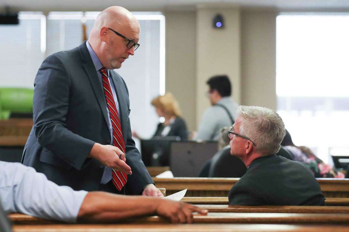 Brian Harris, former assistant chief of the Harris County Precinct 5 Constable's Office, right, talks with his lawyer during a docket call in Judge Patty Maginnis’ 435th state District Court, Wednesday, Nov. 9, 2022, in Conroe. Harris has entered a not-guilty plea on a charge of solicitation of prostitution after he was arrested in September during a prostitution sting by the Montgomery County Sheriff’s Office.