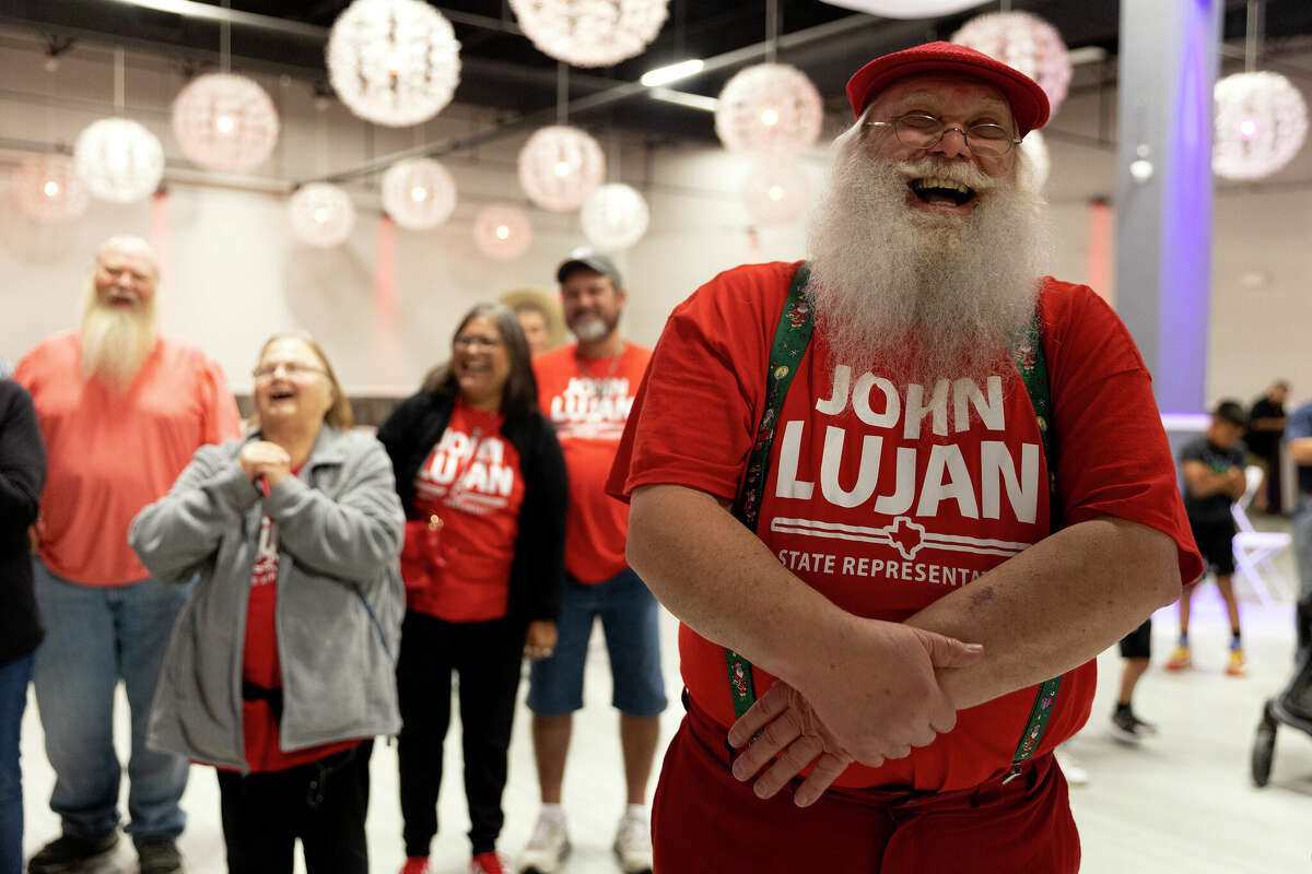Tom Meyer laughs as Republican Rep. John Lujan says goodnight to supporters at his watch party. 