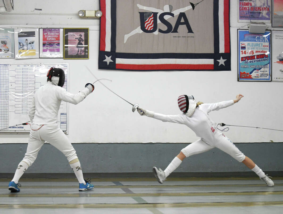 Greenwich's Kyle Fallon, 16, right, spars with Alexander Velikanov at the Fencing Academy of Westchester in Hawthorne, N.Y. Monday, Nov. 7, 2022. Fallon is a nationally top-ranked fencer and won three world championships.