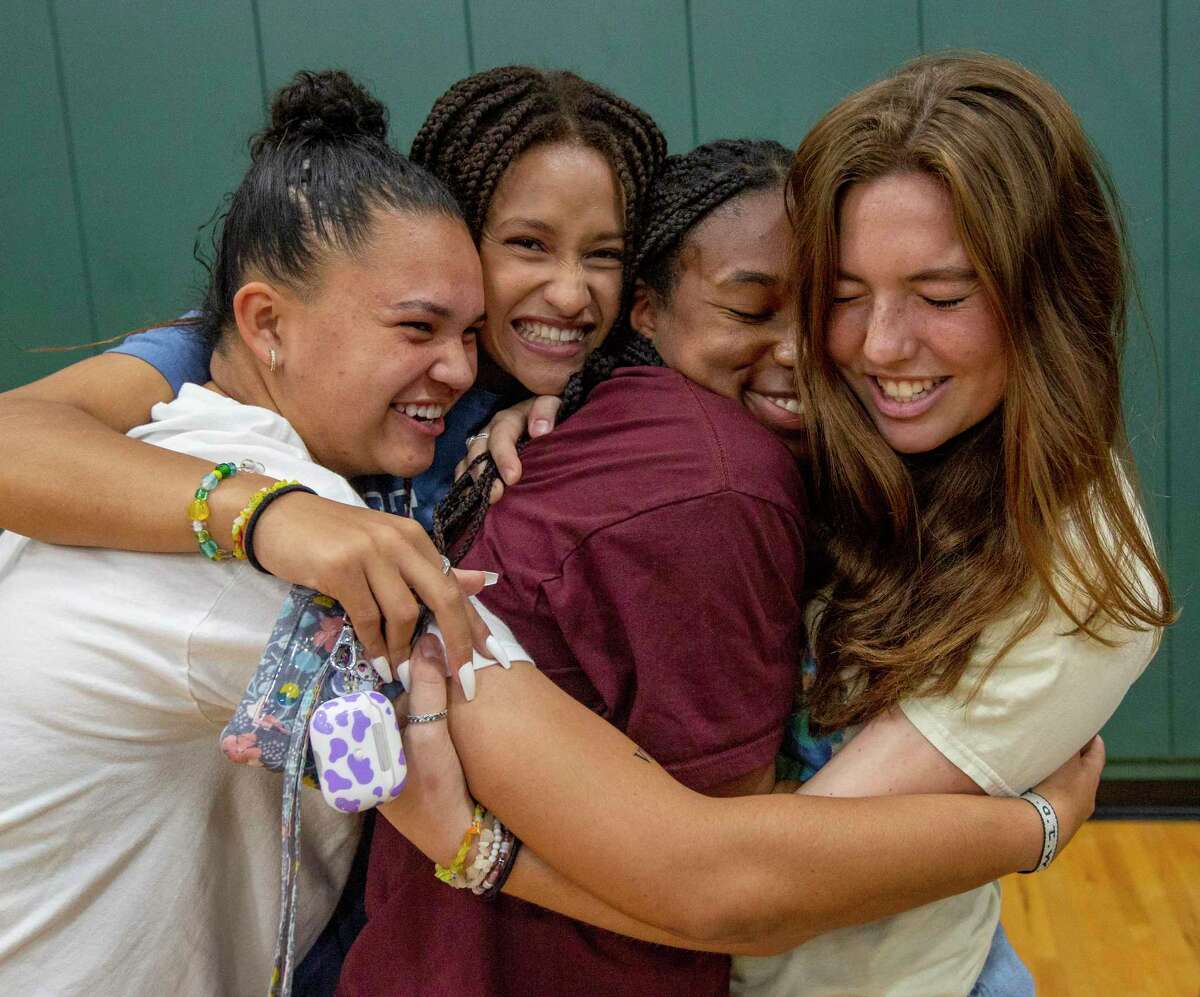 Reagan soccer player Taylor Jernigan, second from right, celebrates Wednesday morning, Nov. 9, 2022 with friends after she signed to play for Texas A&M - College Station during national signing day.