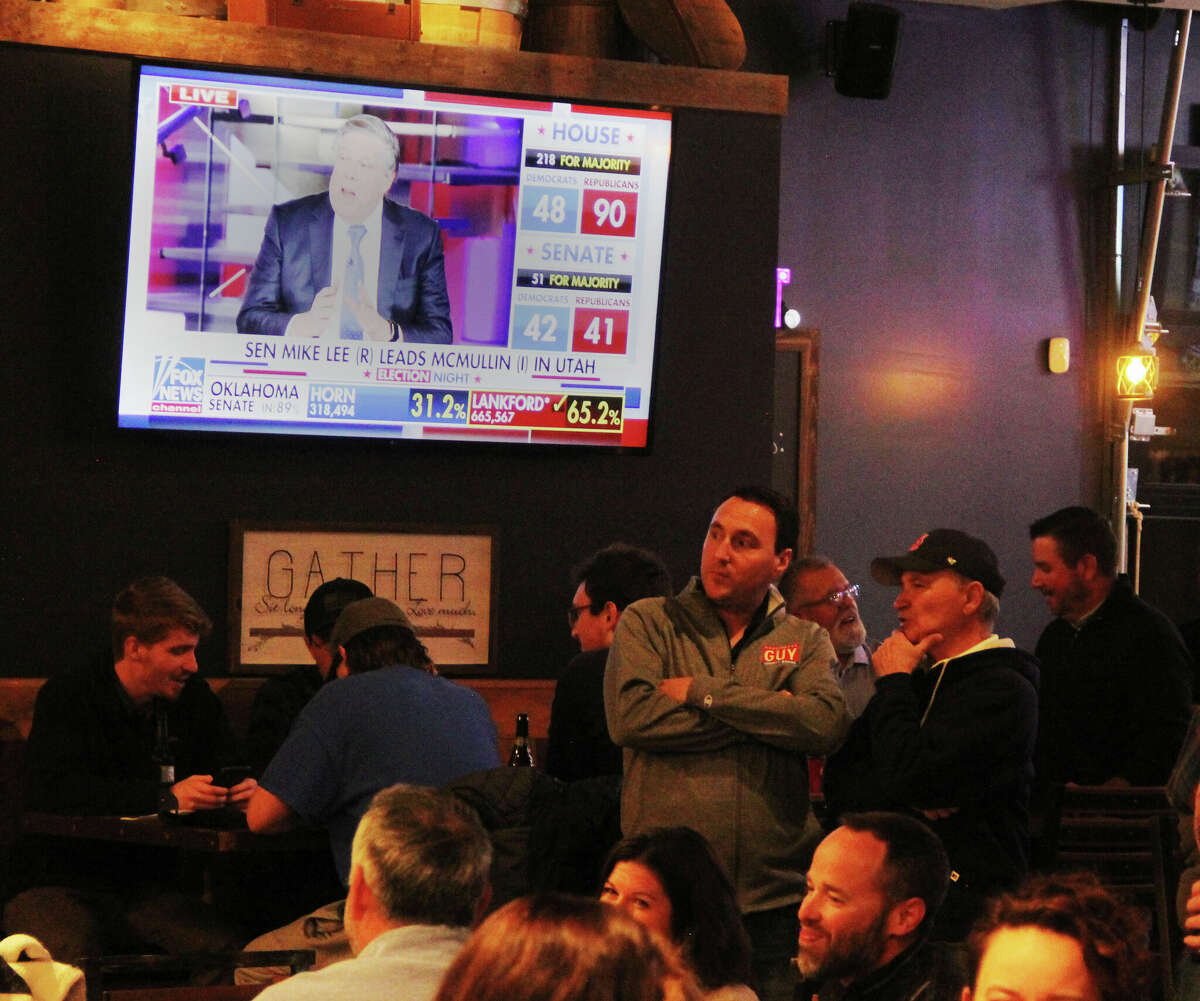 Republicans, including County Board Member and party Vice Chairman Chris Guy watch election returns during a party at Edison's in Edwardsville.