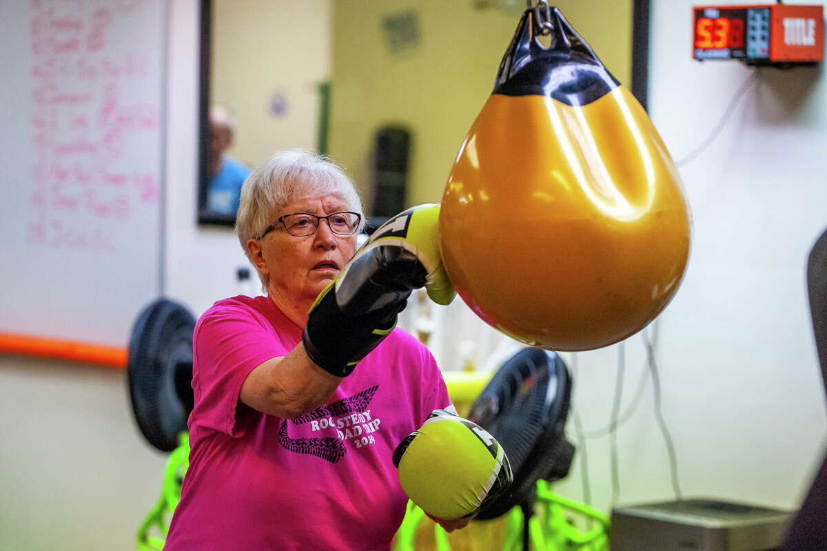 Midland resident Pauline Pittsley, 83, strikes a punching bag at the new location of Rocksteady Boxing on Nov. 9, 2022 at the Midland Mall.