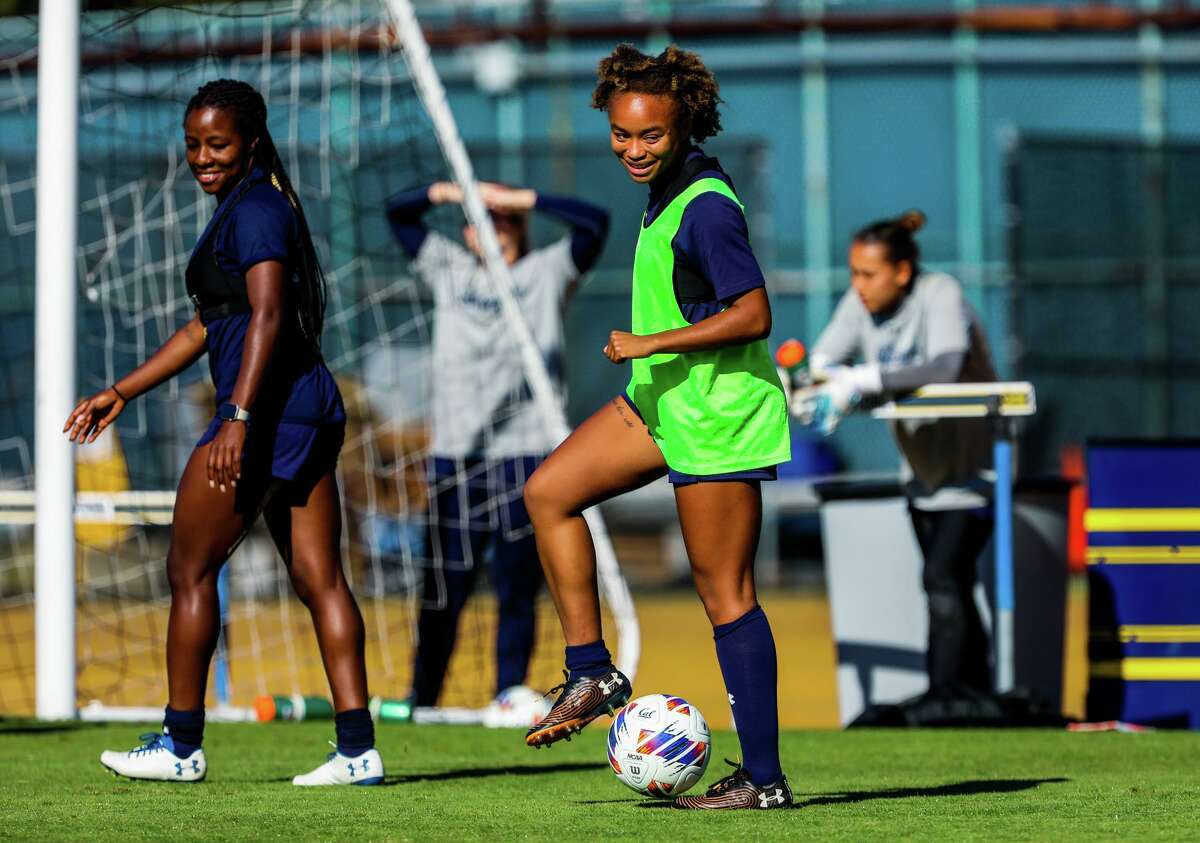 University of California Berkeley forward Anysa Gray (17), center, 20, kicks the ball while practicing soccer with teammates at Edwards Stadium on Wednesday, October 26, 2022, in Berkeley, Calif. Anysa and her twin sister Amaya Gray are juniors who play for the women?•s soccer team. The Grays, of East Palo Alto, faced homelessness during their childhood and worked through their first two years as student athletes.