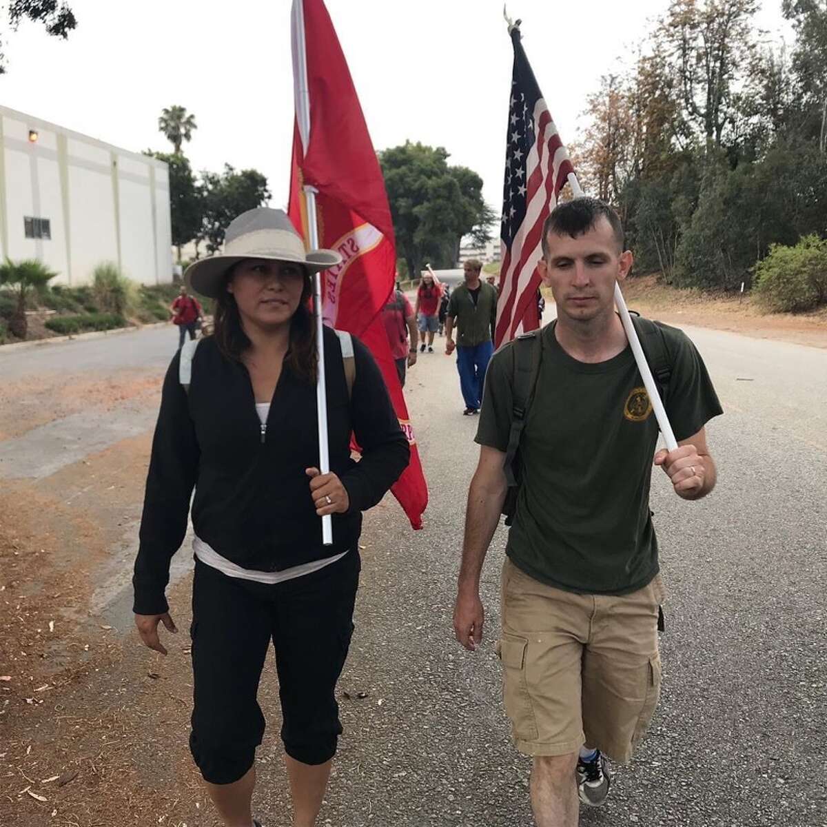 Marine veteran Dustin Pressley walks alongside the widow of a fellow vet who took his own life at last year's Hike for Mental Health in Pearland. 