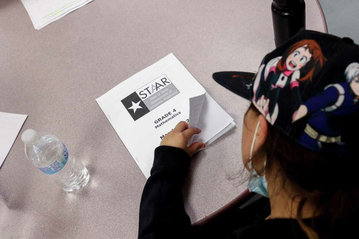 A fourth grader flips open her STAAR mathematics booklet in March. Almost half of Texas students cannot read on grade level, but 87 percent of Texas schools are rated an A or a B. Recent proposals would weaken accountability standards.