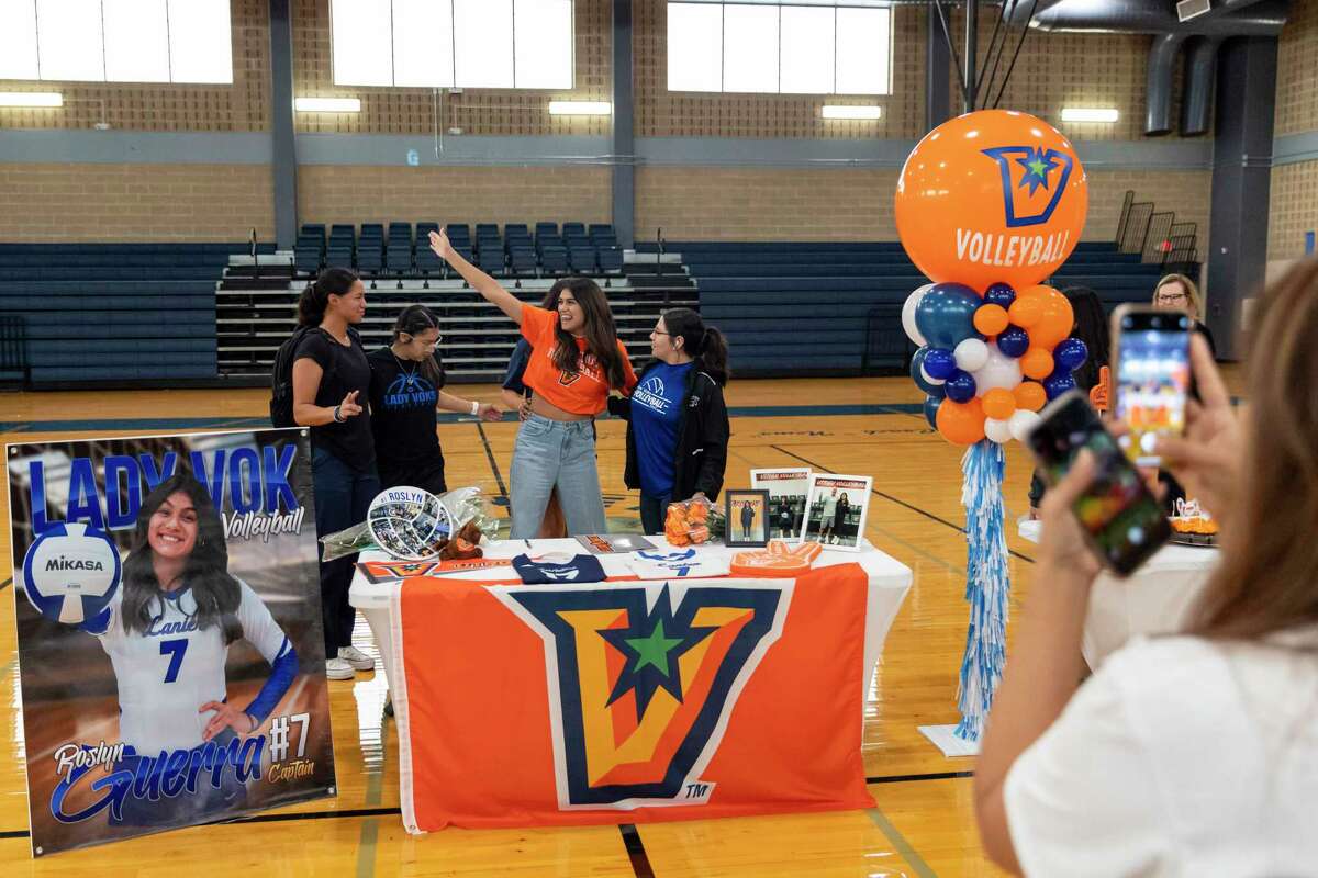 Roslyn Guerra, center, poses with friends for a photo at her signing day at Sidney Lanier High School gym in San Antonio, TX, on Nov. 9, 2022. Guerra is believed to be the first volleyball player from Lanier to sign with a college in more than a decade.