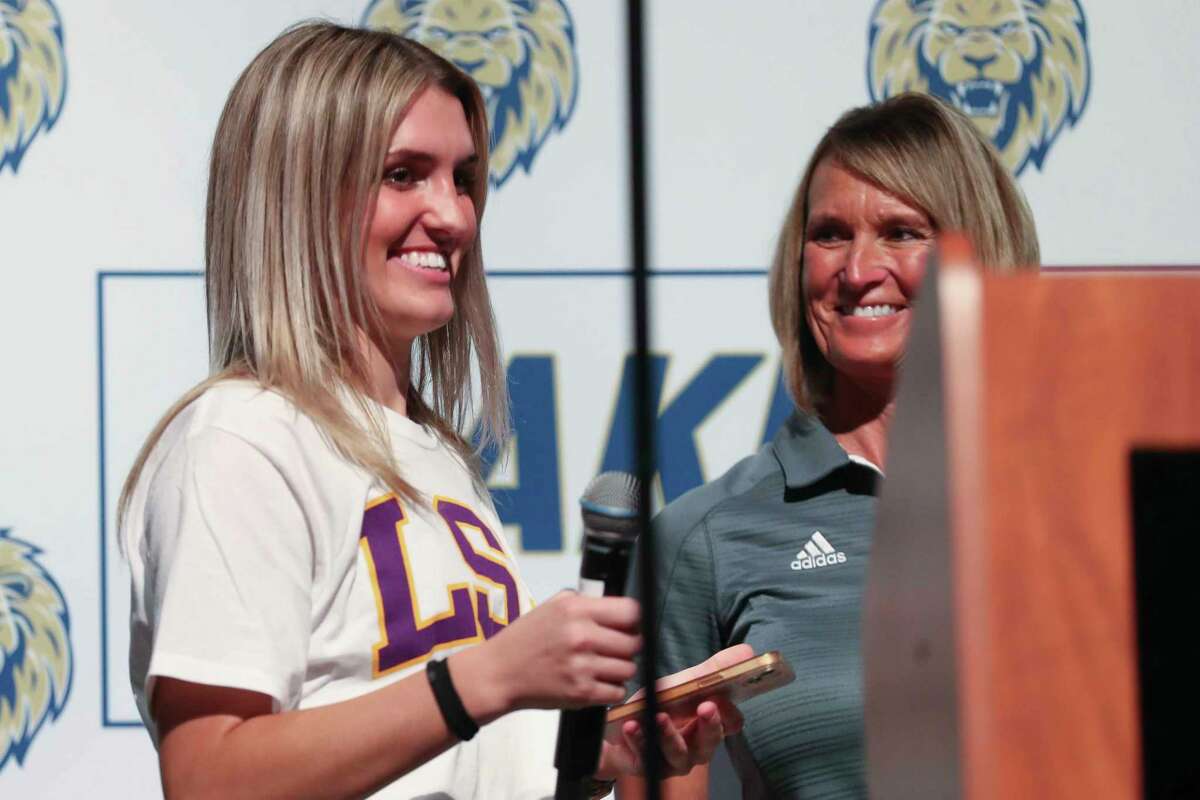 Maddox McKee, left, smiles beside Lake Creek softball coach Michelle Rochinski before signing to lay for LSU during a signing day ceremony at Lake Creek High School, Wednesday, Nov. 9, 2022, in Montgomery.
