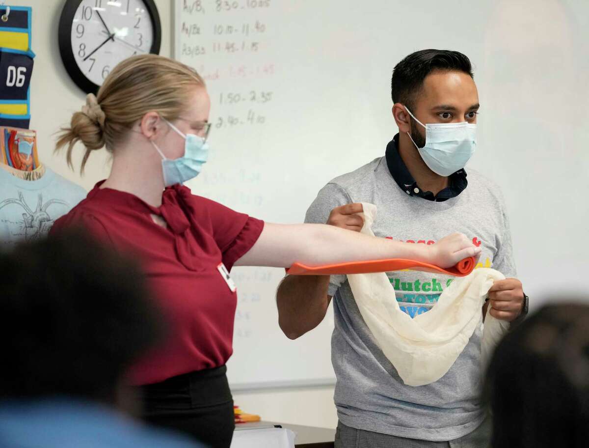 Nabeel Ahmad, right, demostrates applying a splint connected  the limb  of Sierra Cowan, arsenic  the aesculapian  students from the University of Houston College of Medicine enactment    with students Jack Yates High School Wednesday, Nov. 9, 2022, successful  Houston. In the Healthcare Collaborative, aesculapian  students service  arsenic  mentors to students who are funny   successful  pursuing a vocation  successful  wellness  sciences.