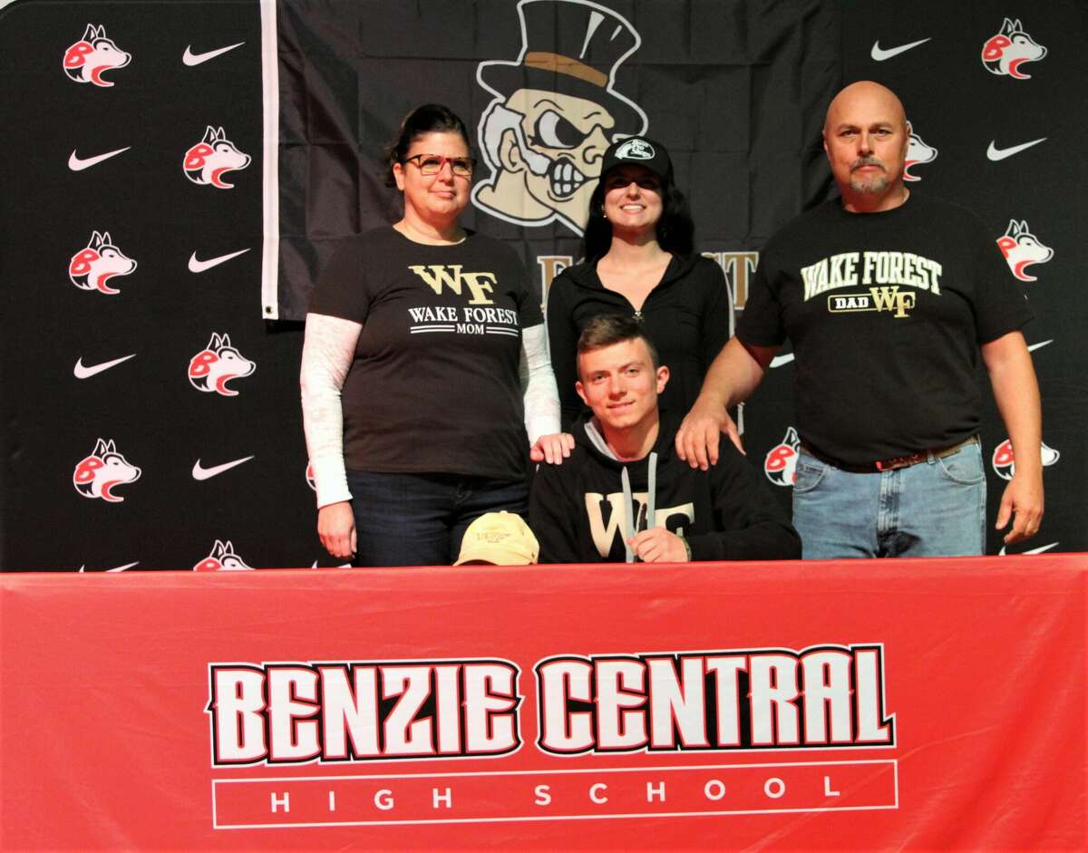 Benzie Central senior Hunter Jones (middle) poses for a photo with his family before signing his National Letter of Intent to Wake Forest on Nov. 9 at Benzie Central High School. 