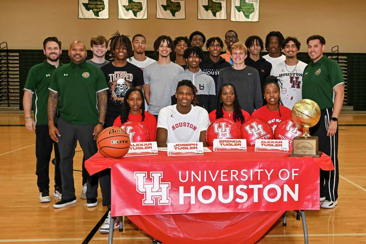 Cypress Falls High School class of 2023 basketball player Joseph Tugler poses with family, coaches and teammates during the signing his National Letter of Intent to play basketball at the University of Houston on November 9, 2022.