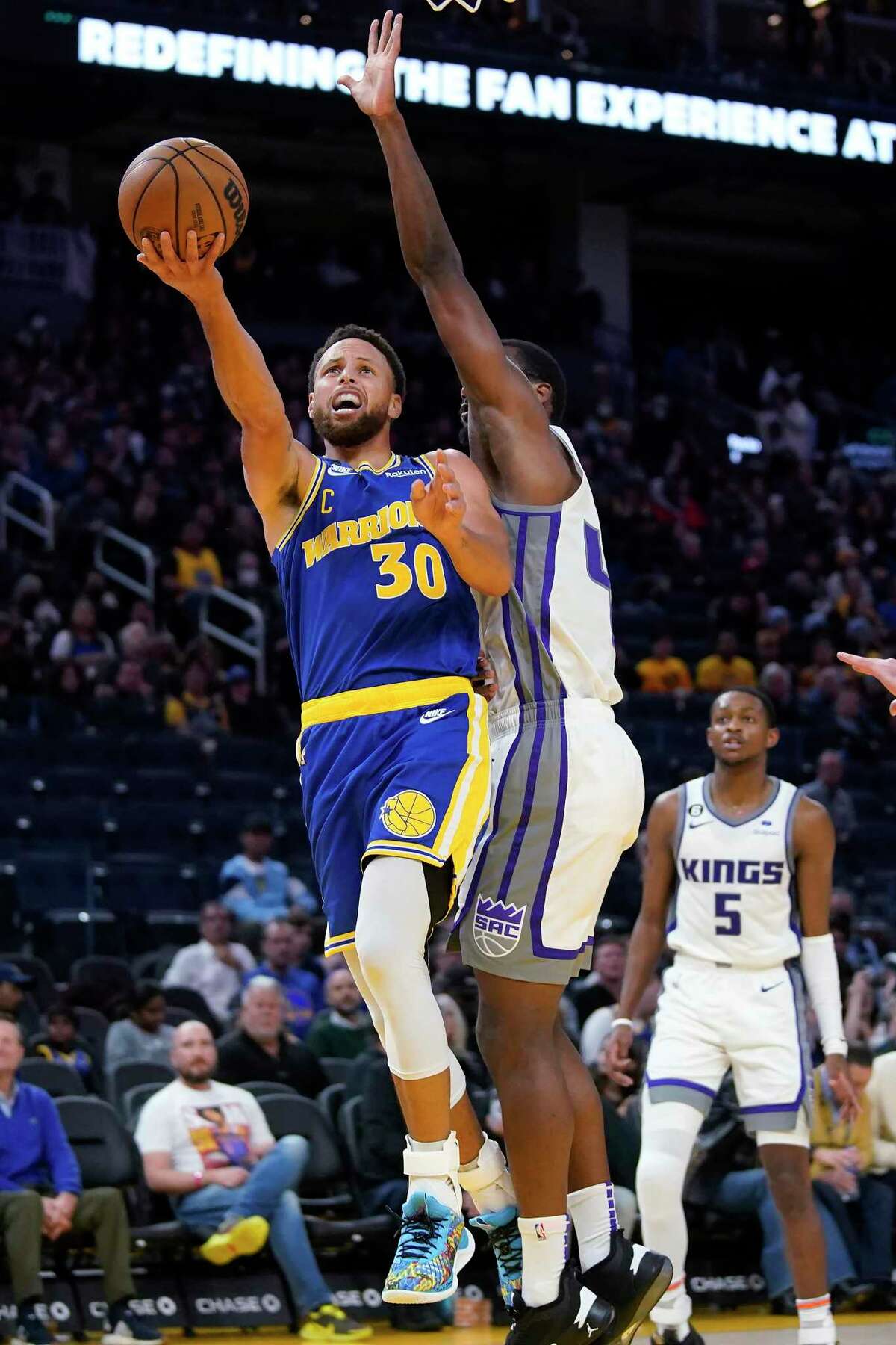 Golden State Warriors guard Stephen Curry (30) shoots against Sacramento Kings forward Harrison Barnes during the second half of an NBA basketball game in San Francisco, Monday, Nov. 7, 2022. (AP Photo/Jeff Chiu)