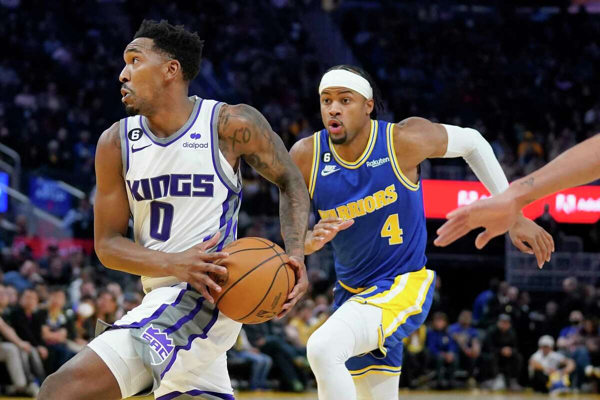 Sacramento Kings guard Malik Monk (0) drives to the basket in front of Golden State Warriors guard Moses Moody (4) during the first half of an NBA basketball game in San Francisco, Monday, Nov. 7, 2022. (AP Photo/Jeff Chiu)