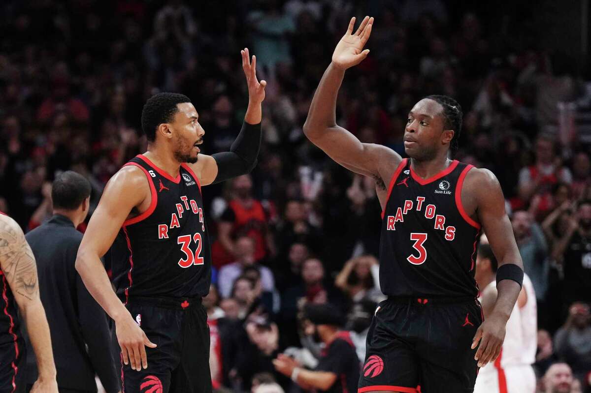 Toronto Raptors forward Otto Porter Jr. (32) and forward O.G. Anunoby (3) celebrate a basket against the Houston Rockets during the second half of an NBA basketball game Wednesday, Nov. 9, 2022, in Toronto. (Nathan Denette/The Canadian Press via AP)
