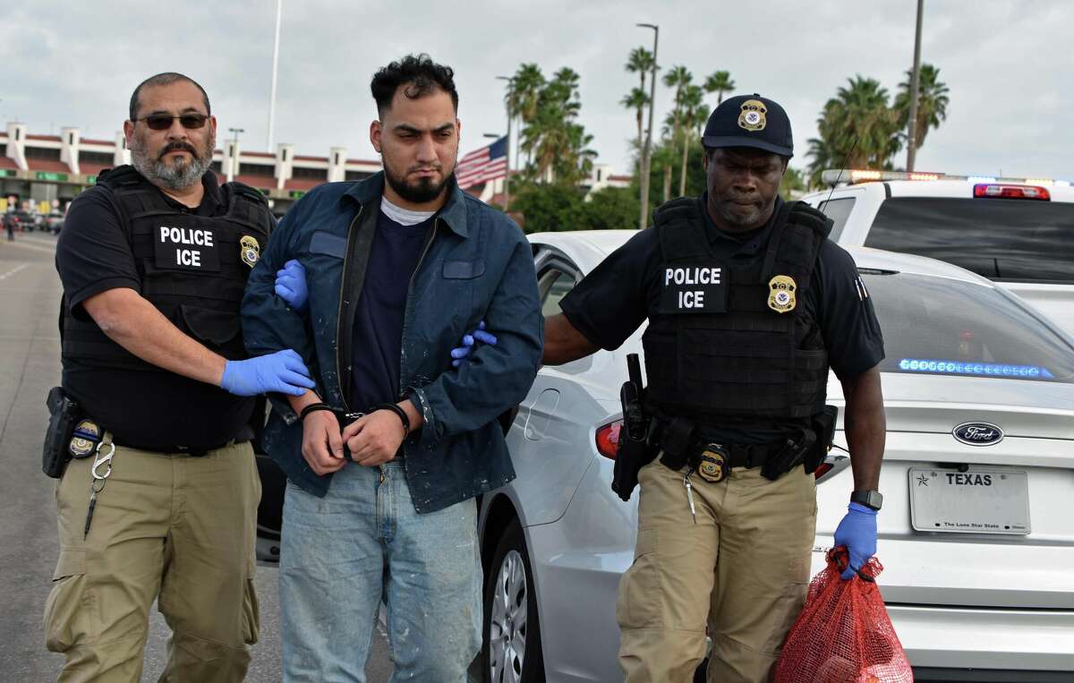 ICE agents escort Osmar Mendez Martinez, 34, to the Juarez-Lincoln Bridge in Laredo, Texas on Wednesday, Nov. 9, 2022. Mendez is wanted for a 2015 murder and was arrested in Houston in February.