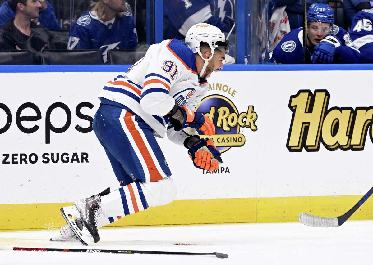 Edmonton Oilers left wing Evander Kane (91) heads to the bench after being cut during the second period of an NHL hockey game against the Tampa Bay Lightning Tuesday, Nov. 8, 2022, in Tampa, Fla. (AP Photo/Jason Behnken)