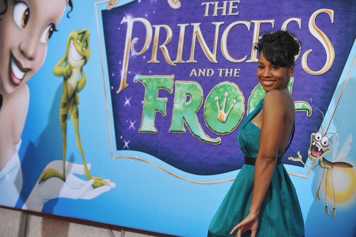 Actress Anika Noni Rose, the voice of Princess Tiana (at left on the poster), poses as she arrives for the world premiere screening of Disney's "The Princess and The Frog," at Walt Disney Studios in Burbank, California on November 15, 2009. Princess Tiana is Disney's first African-American princess. AFP PHOTO/Robyn Beck (Photo credit should read ROBYN BECK/AFP via Getty Images)