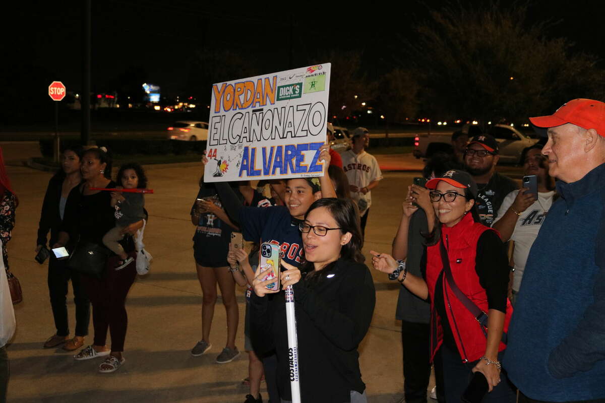 Those in the back of a line of Astros fans at Dick's Sporting Goods Wednesday night catch a glimpse of Astro Yordan Alvarez as he exits a vehicle in the loading dock area.