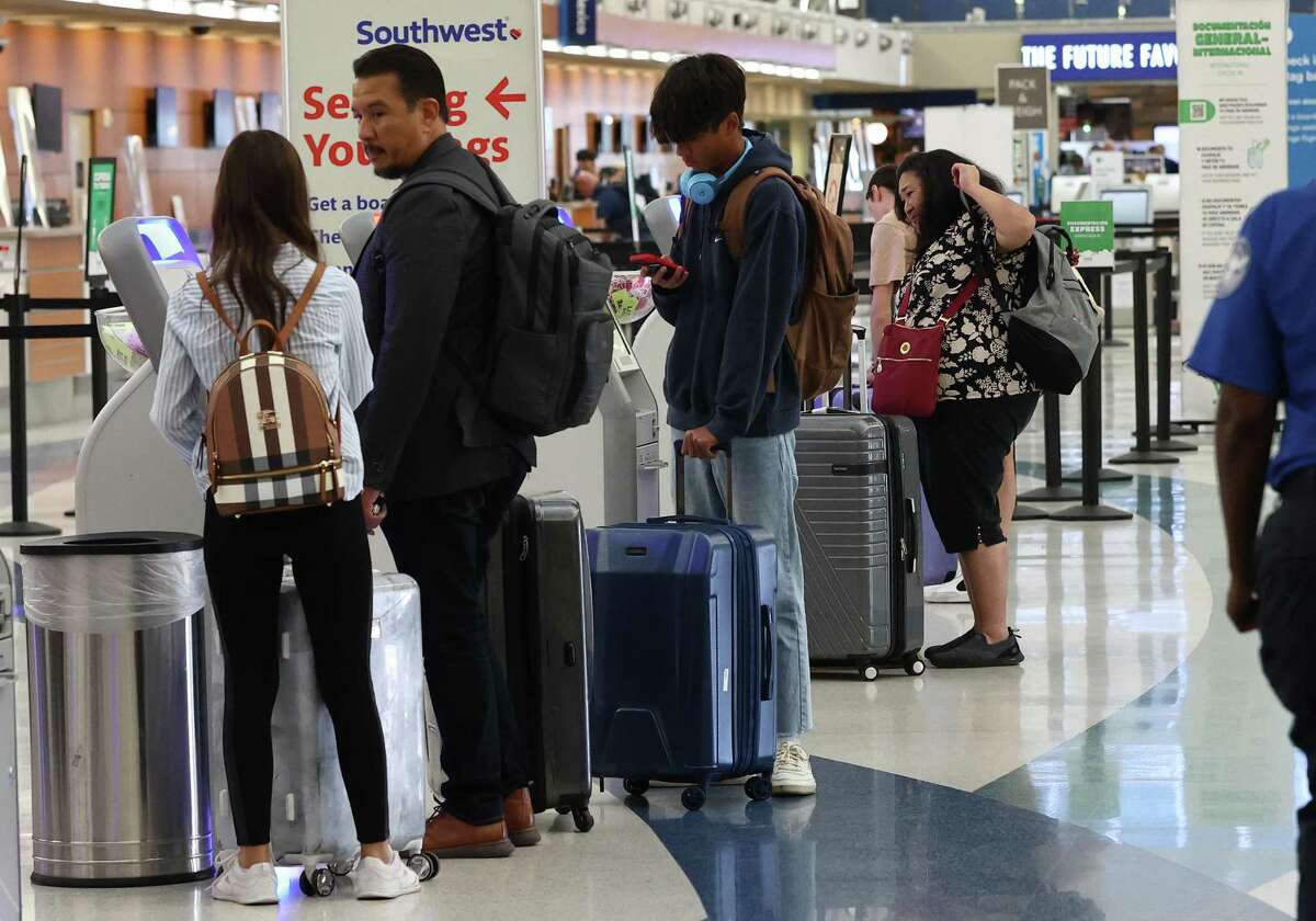Travelers await to check in for their Southwest Airlines flight at the San Antonio International Airport on Wednesday, Oct. 12, 2022.