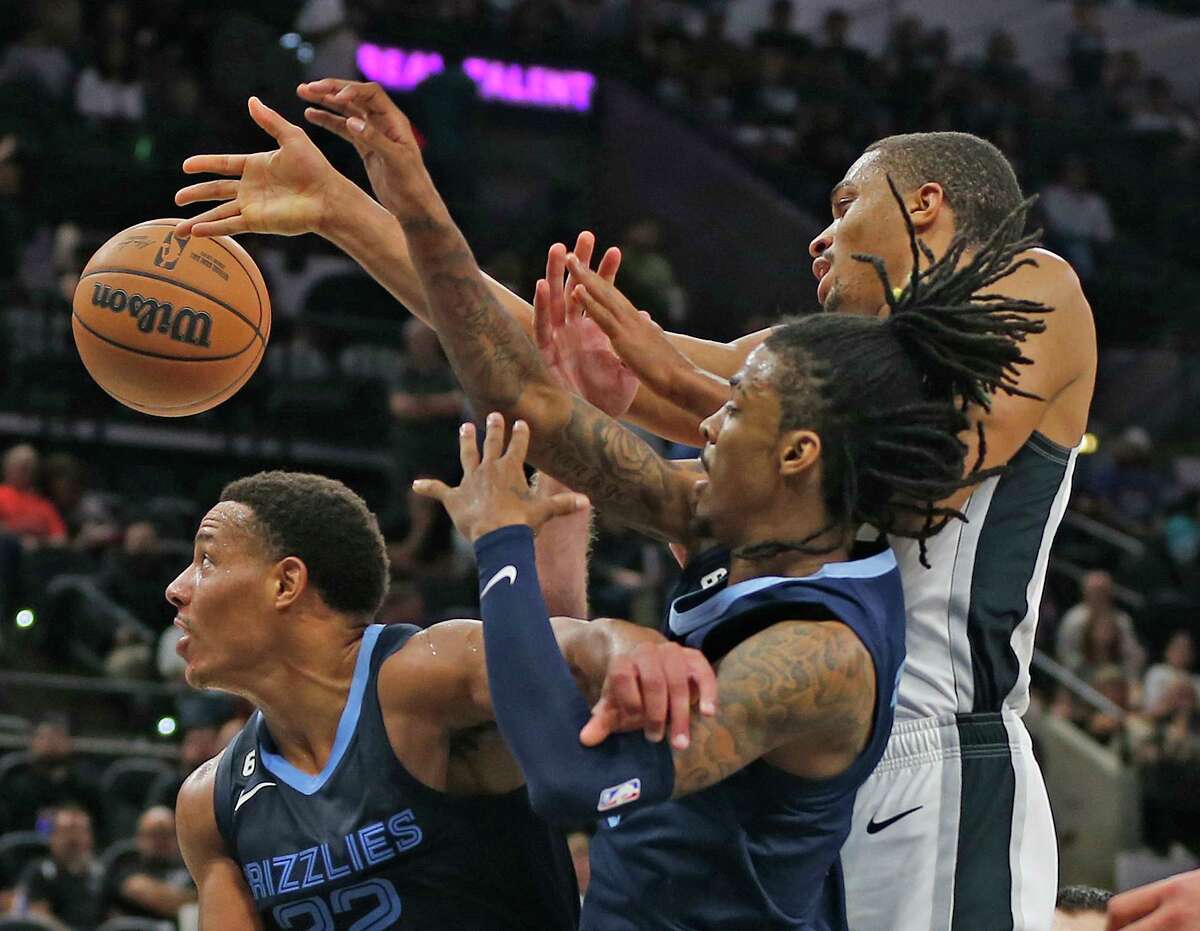 San Antonio Spurs Keldon Johnson (3) battles Memphis Grizzlies Desmond Bane (22) and Ja Morant (12) for a rebound in OT on Wednesday, Nov. 9, 2022 at AT&T Center. Grizzlies defeated San Antonio Spurs 124-122 in OT.