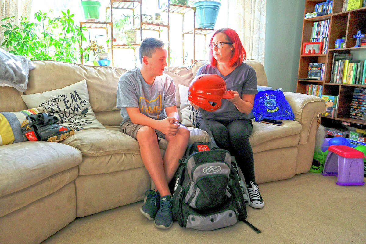Liam Kennedy and his mother, Rachel, go through an equipment bag.