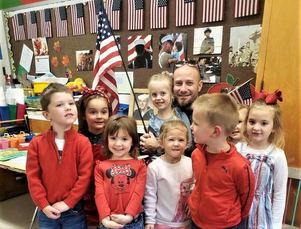 Lynne Gatz's preschool students at Trinity Lutheran pose for a photo Thursday with U.S. Air Force veteran Dan Broadbent.