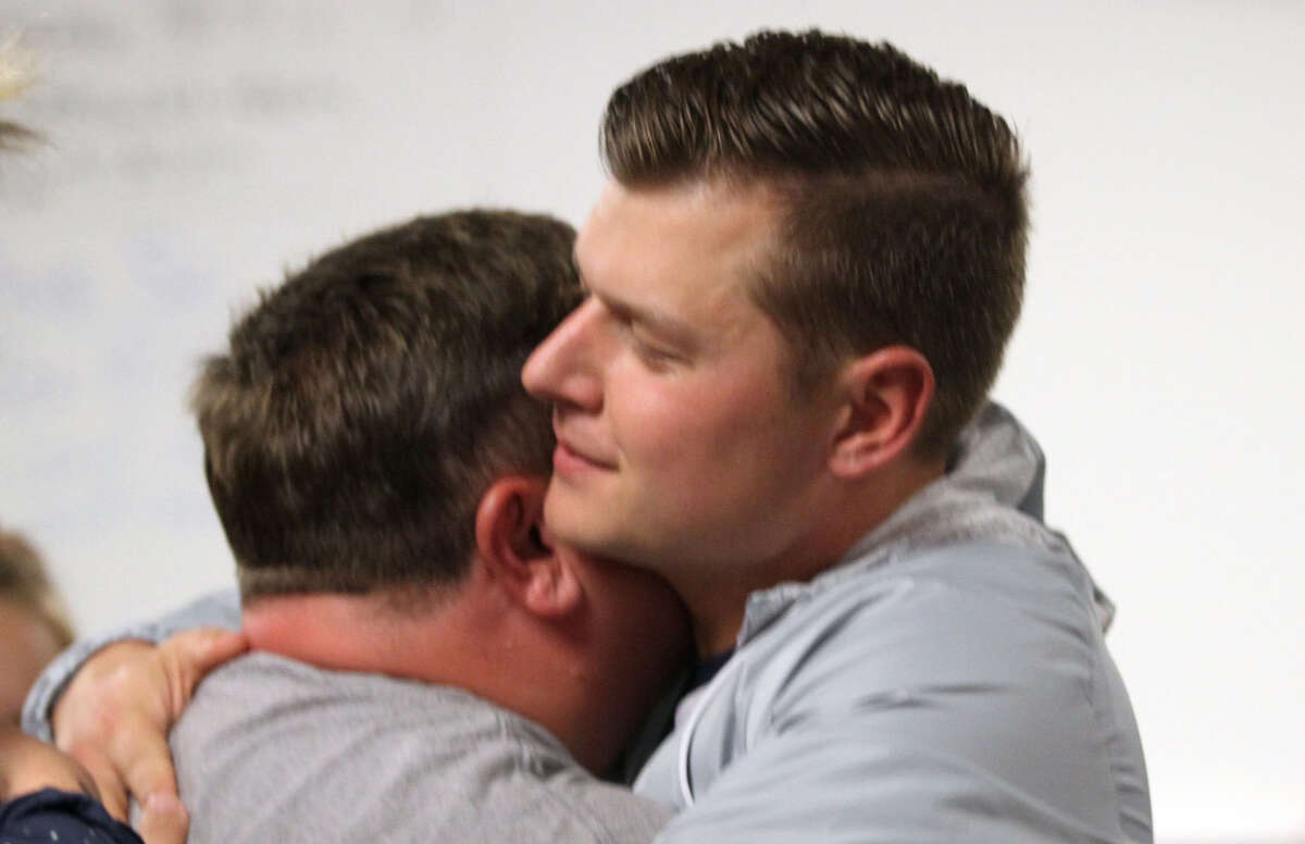 Former Laker teacher and coach Justin "Jay" Dubs, right, receives support at a Laker school board meeting on Sept. 16, 2019. A Huron County jury has sided with Dubs, who filed a civil lawsuit after he said he was falsely accused by a player in 2019 of kissing her.