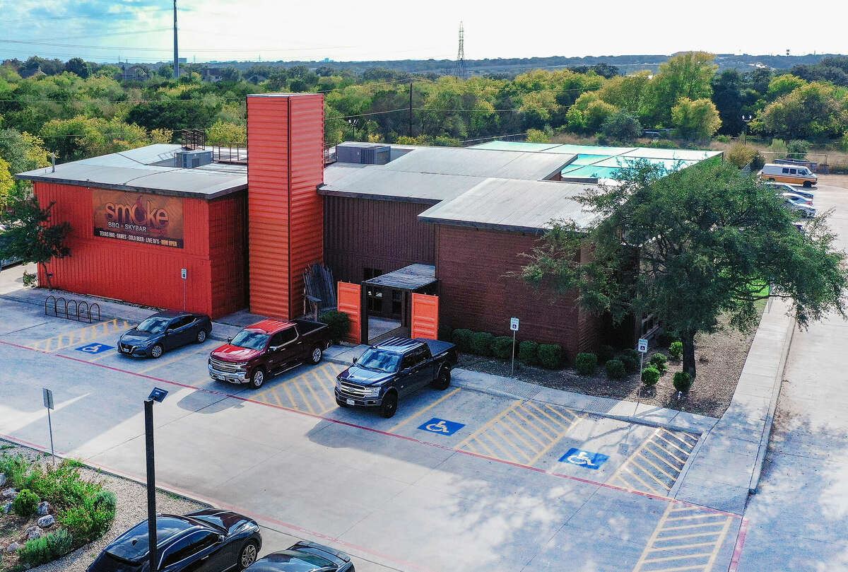 The second floor features a private banquet room, a large bar, and an outdoor balcony overlooking the exterior venue.