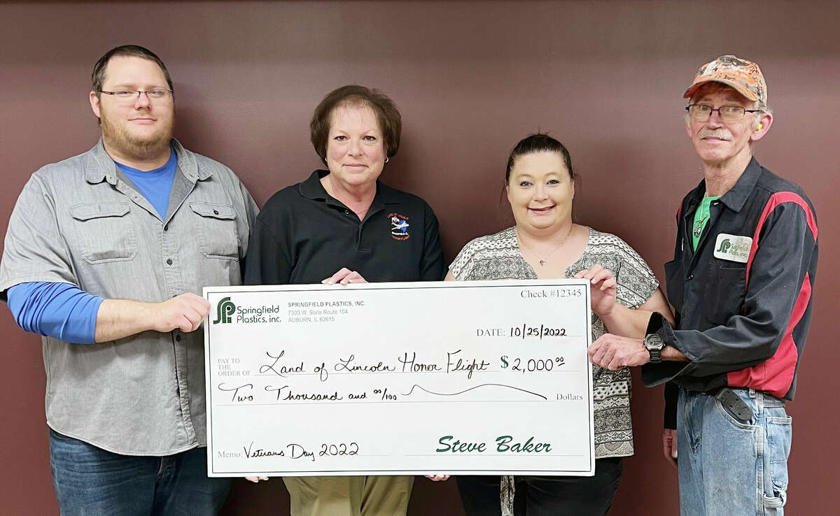 Joan Bortolon (second from left), president of Land of Lincoln Honor Flight, accepts a $2,000 donation from Wesley Foreman (from left), Andrea Schroll and Steve Harbour of Springfield Plastics. 