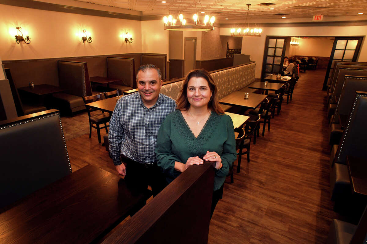 Brother and sister owners Dean Kotsaftis and Catherine Rountos pose in the dining room of the newly renovated Old Towne Restaurant, in Trumbull, Conn. Nov. 10, 2022.