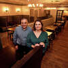 Brother and sister owners Dean Kotsaftis and Catherine Rountos pose in the dinning room of the newly renovated Old Towne Restaurant, in Trumbull, Conn. Nov. 10, 2022.