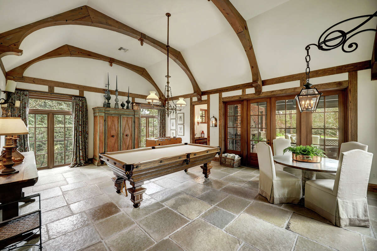 The first floor game room has outdoor access and 18th century Portuguese cathedral stone.