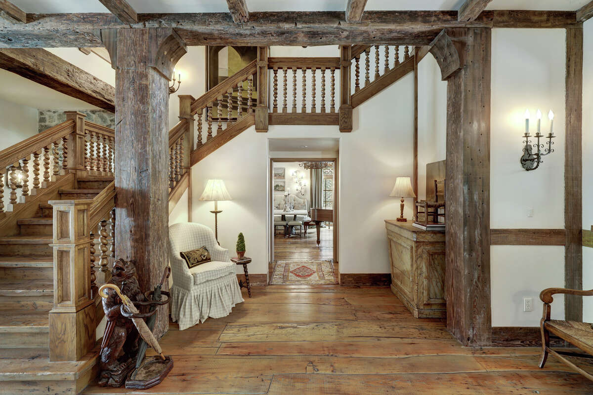 Antique pine beams and hand-hone front stairway balusters greet visitors in the foyer.