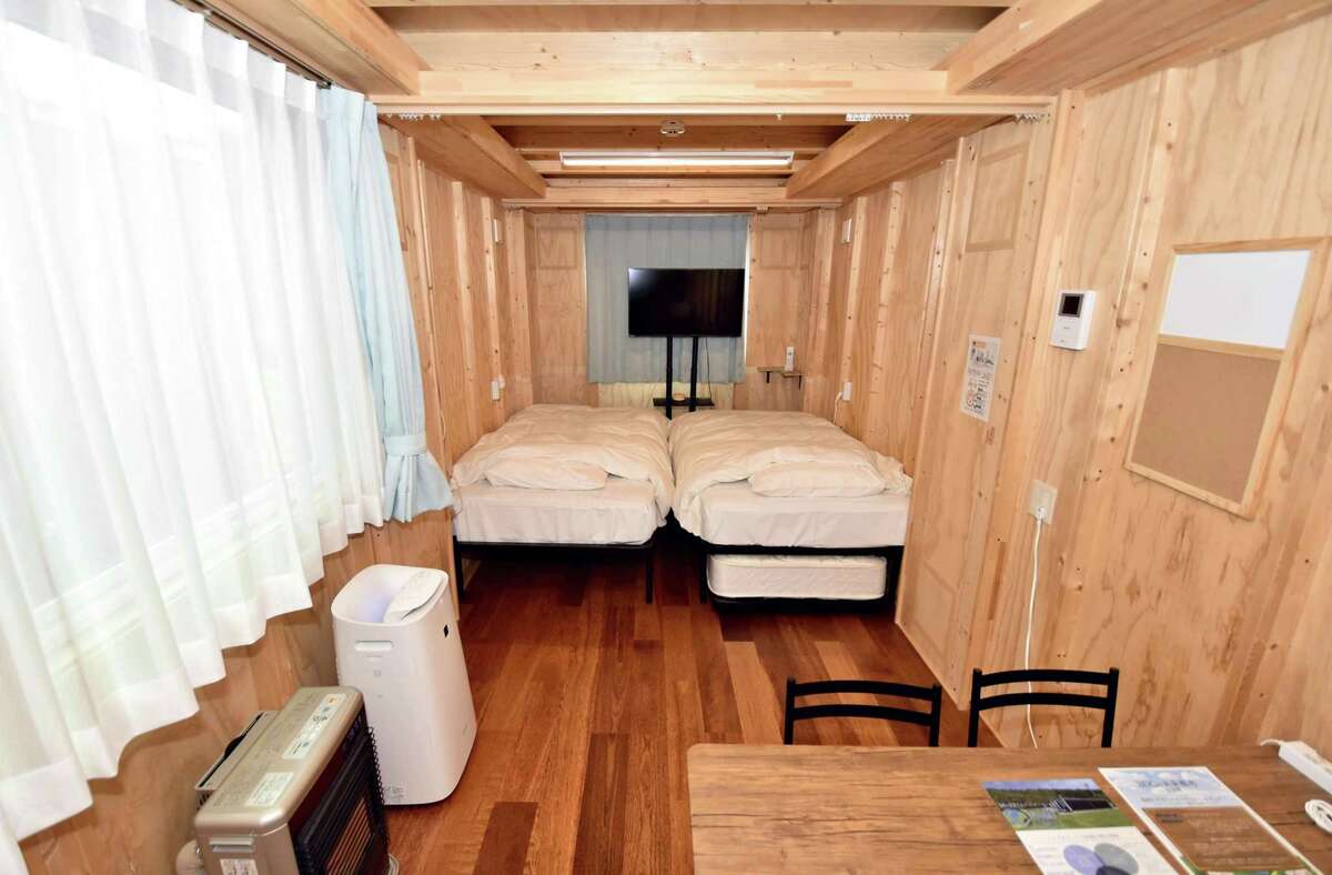 A guest room of a hotel incorporating temporary housing units for disaster victims.