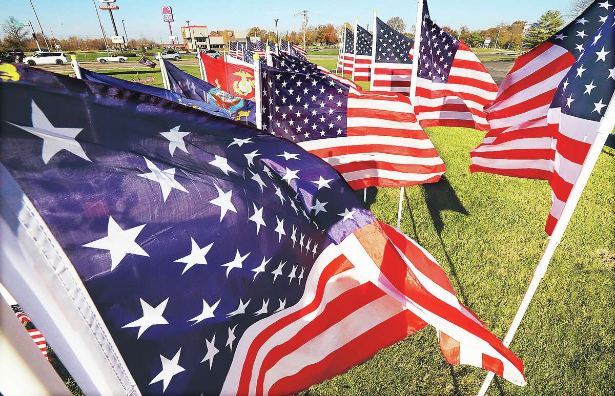 John Badman|The Telegraph The many flags at the corner of Illinois 111 and 140 in Bethalto were taking a wild ride in the wind Thursday. The flags, set out by local flag man Fred Smith, are there to remember people on Veterans Day. Smith, a U.S. Army veteran, is responsible for nearly all of the large flag displays seen around the Riverbend.