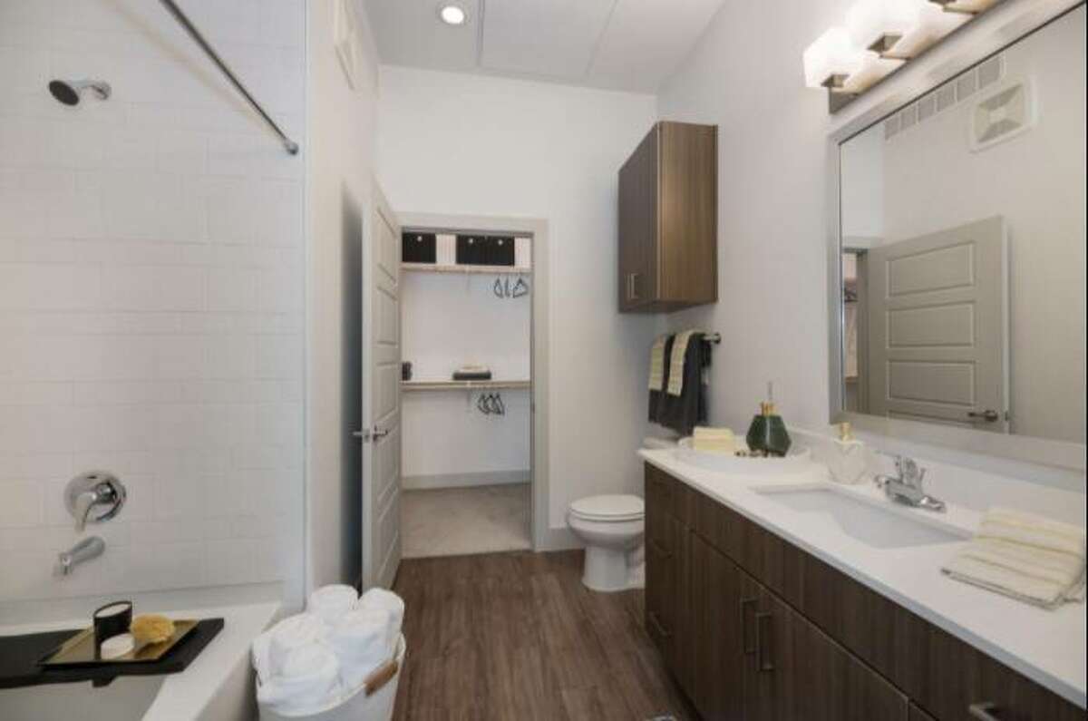 This bathroom is not shy with the wood panel flooring.