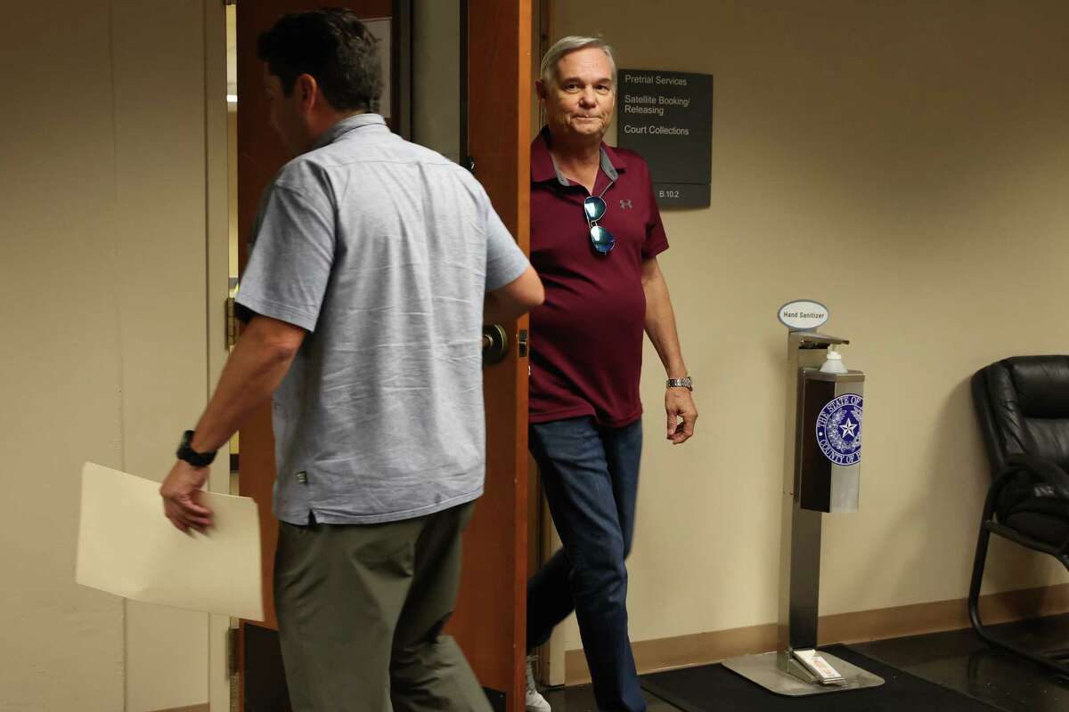 San Antonio City Council member Clayton Perry leaves a satellite court after surrendering after he was issued an arrest warrant on misdemeanor charges, Thursday, Nov. 10, 2022. His charges are related to a hit and run accident on Sunday. With him is his attorney, David Christian.