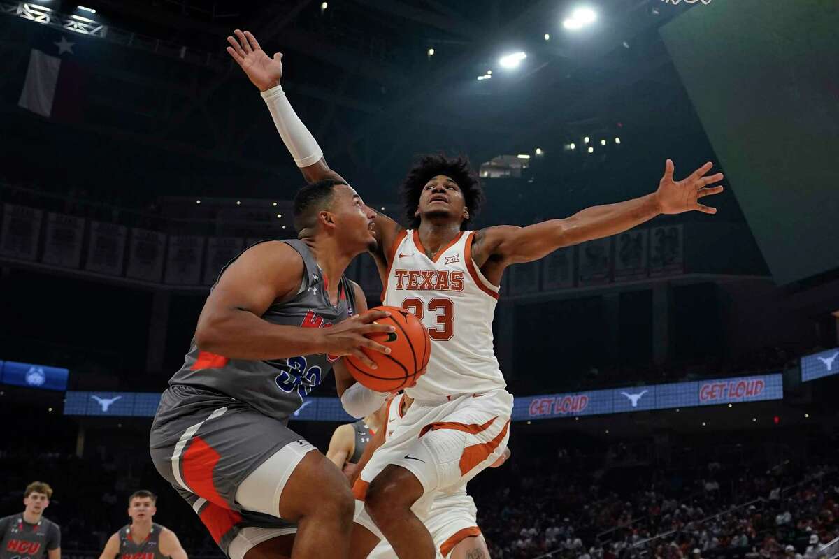 Texas forward Dillon Mitchell, a big reason the Longhorns rank third nationally in defensive efficiency, ninth in scoring defense and 13th in opponent field-goal percentage, sets up a roadblock on Houston Christian forward Sam Hofman in their Nov. 10 meeting at Austin.