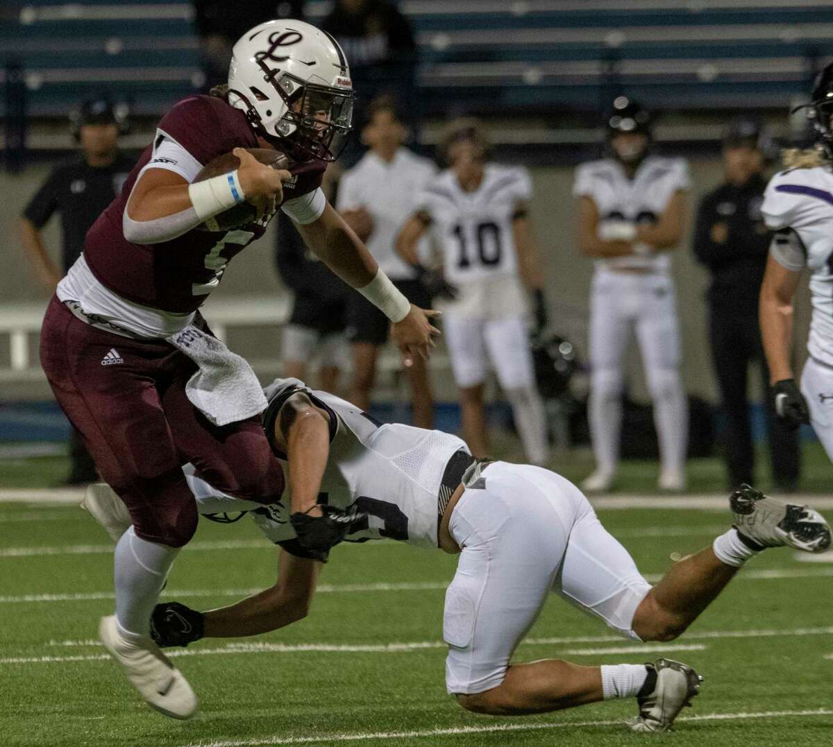 Legacy High's Marcos Davila tries to get around a diving tackle by El Paso Franklin's Elliot Varela 11/10/2022 at Astound Broadband Stadium. Tim Fischer/Special to the Reporter-Telegram