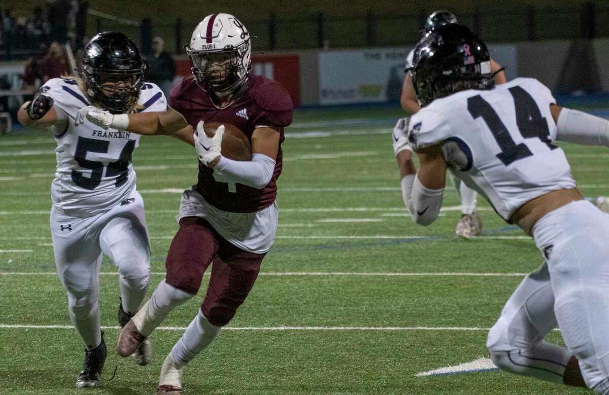 Legacy High's Aiden Serrano looks for more yards as El Paso Franklin's Peter Mosqueda and Yahir Ramirez close in 11/10/2022 at Astound Broadband Stadium. Tim Fischer/Special to the Reporter-Telegram