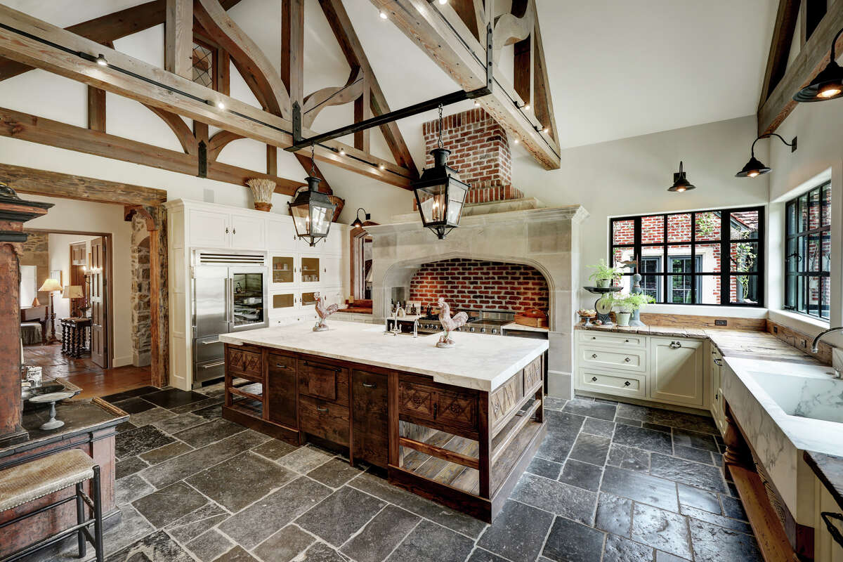 Antique Belgian blue limestone flooring and 200-year-old French oak countertops create an otherworldly ambiance in the chef's kitchen.
