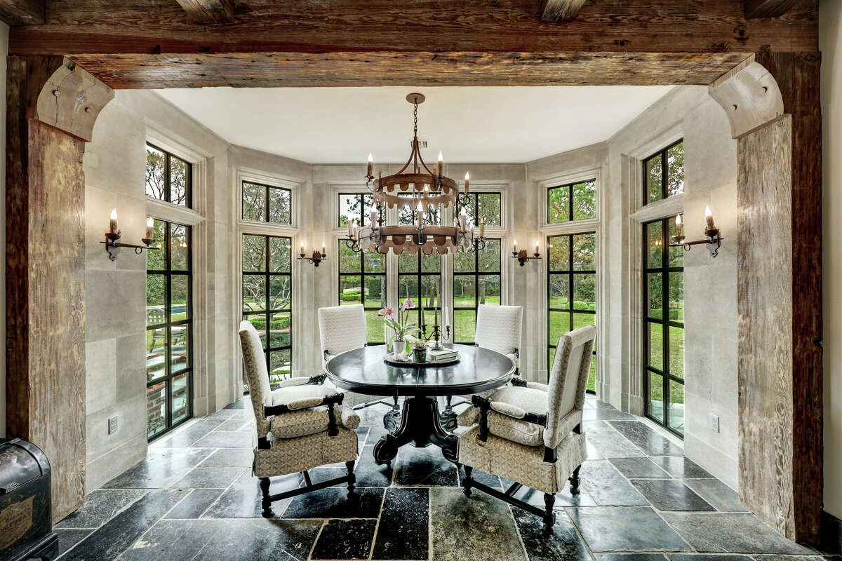 The dining room is surrounded by large windows to let in natural light.