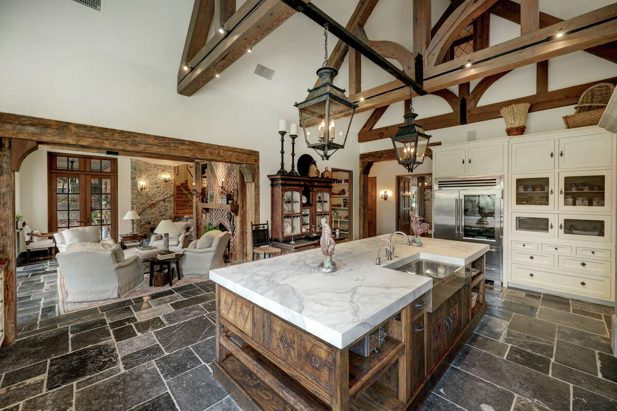 The kitchen's island is fabricated from an antique table topped with marble.
