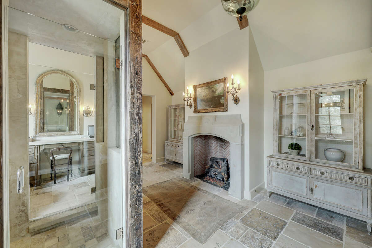 A walk through shower and fireplace are features of the primary bathroom.