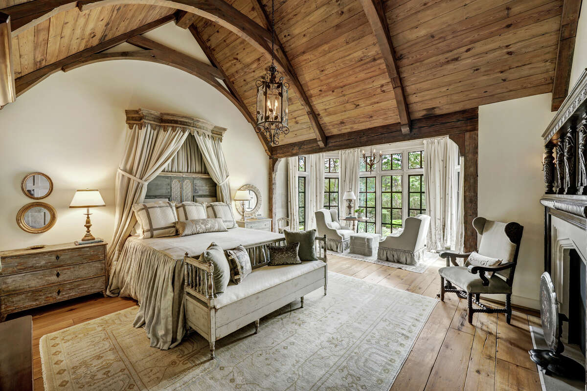 The primary bedroom has a cathedral ceiling with reclaimed pine wood and a sitting room.