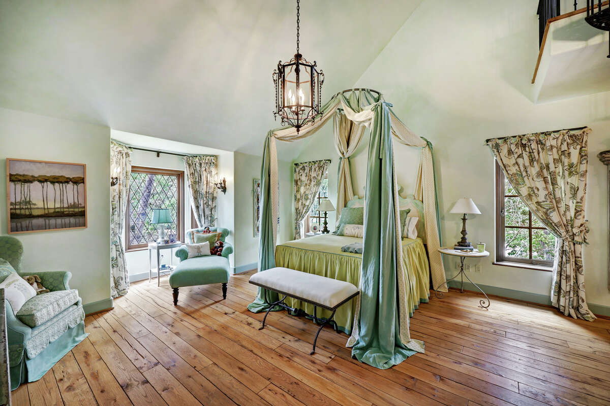Hand-beveled antique floors continue into the guest bedrooms.