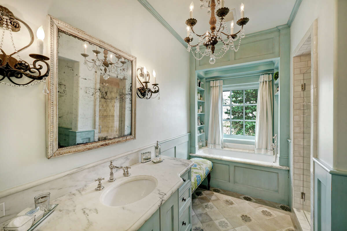 The guest suite's bathroom has a soaking tub with marble surround and a picture window.