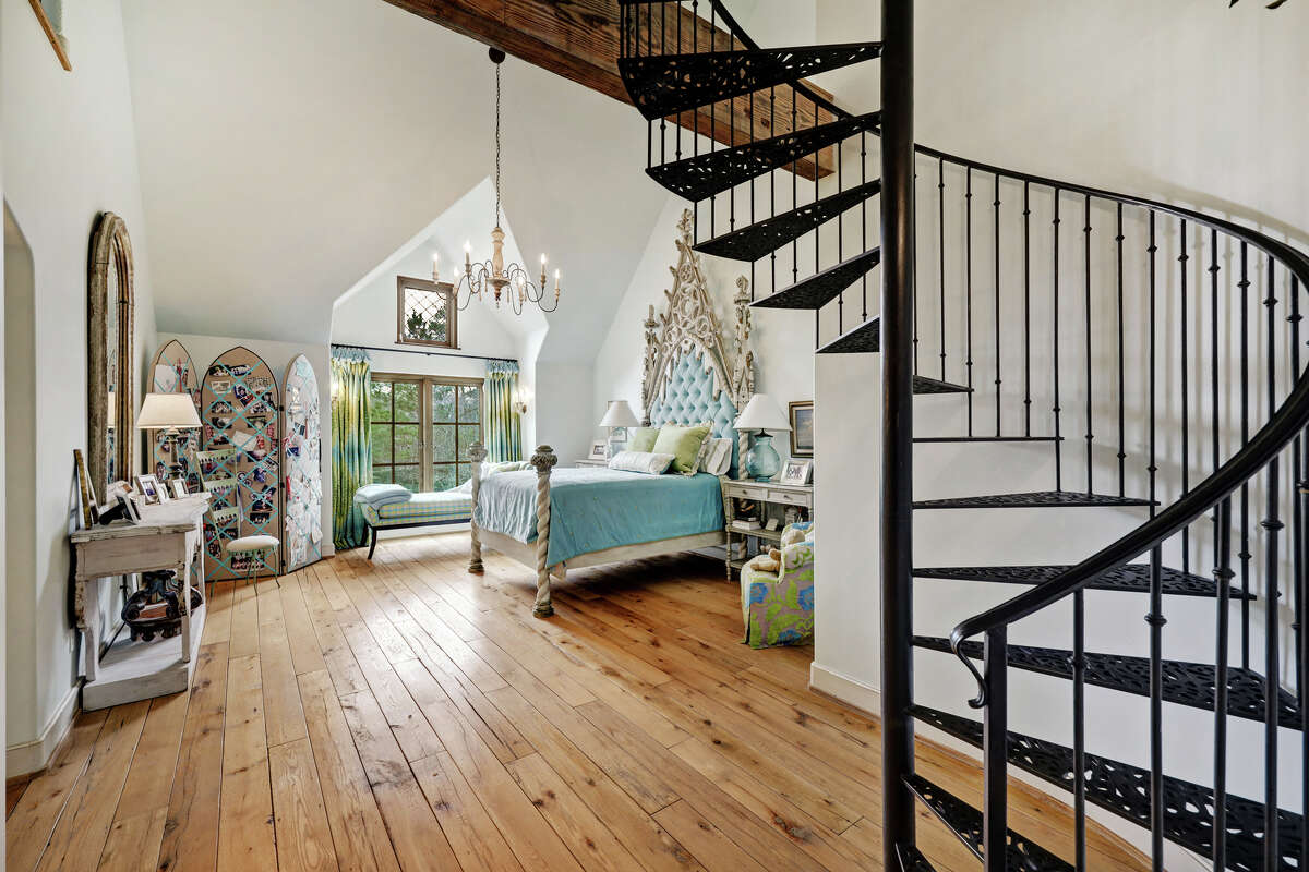 Two guest bedrooms include a spiral staircase leading to a loft.